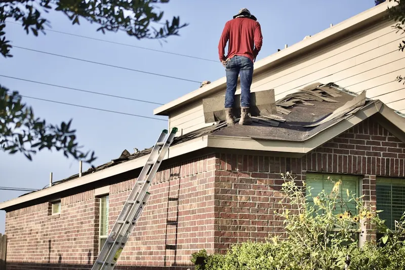 Professional roofer working on a residential roof in Beverly Manor